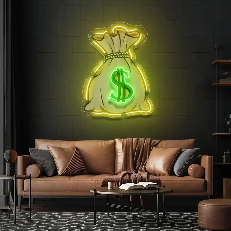 A custom neon sign shaped like a money bag with a green dollar symbol in the center. The outline of the bag glows in bright yellow, while the dollar sign itself is illuminated in a vivid green. The sign is mounted on a dark wall, adding a pop of color to the modern living room setup, with a leather sofa and contemporary decor. The neon sign’s bold design brings an edgy, playful vibe, making it an eye-catching decorative element. Perfect for those looking to add a touch of personality and style to their space.