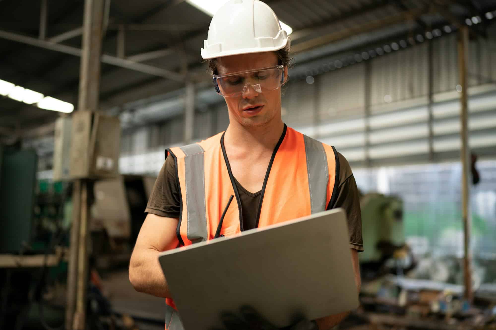 Metal industry worker at factory in work wear